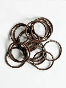 Brown round-section O-rings arranged on a white surface.