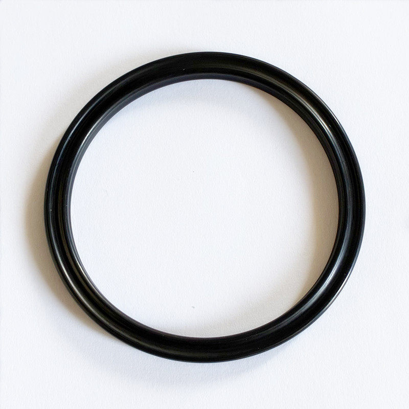 Single black sealing ring viewed from above, showing its grooved circular profile.