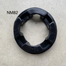 Black NM82 flexible coupling insert showing four inward-facing pads and molded model marking.