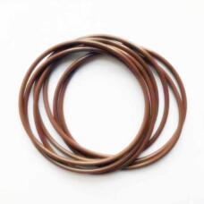 Several overlapping brown round-section O-rings on a white surface.