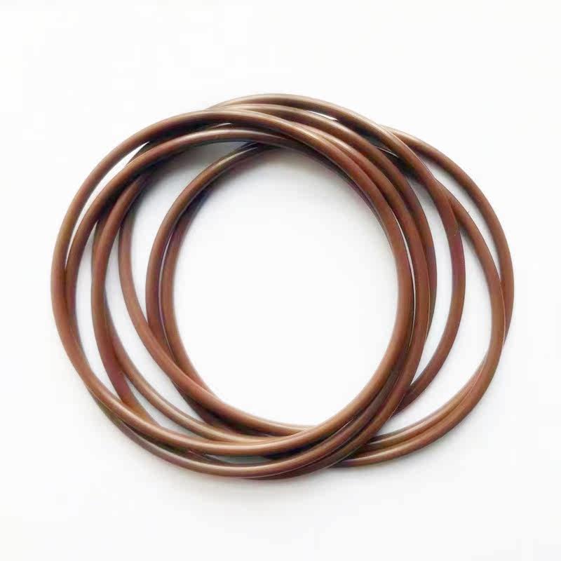Several overlapping brown round-section O-rings on a white surface.