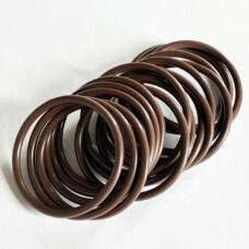 Brown round-section O-rings arranged in an overlapping row on a white surface.