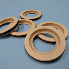 Beige annular seals showing recessed inner faces and dark outer sealing bands.