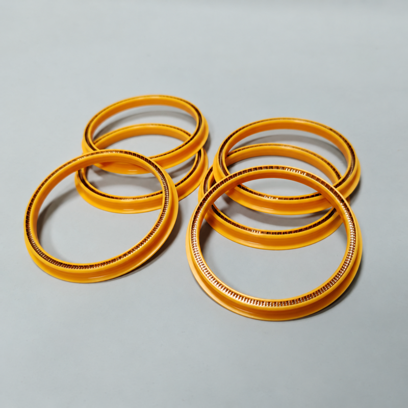 Six yellow annular seals in overlapping groups, with metal spring elements visible along their inner edges.