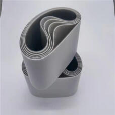 Two stacked coils of wide grey belts showing their smooth outer faces and toothed inner surfaces.