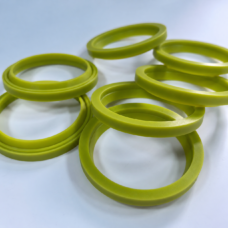 Yellow-green lip seals arranged in overlapping groups, showing their raised inner sealing profiles.
