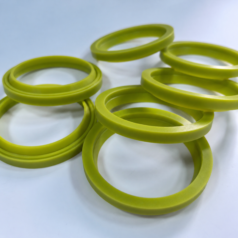 Yellow-green lip seals arranged in overlapping groups, showing their raised inner sealing profiles.